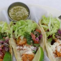 Tacos · Three soft tacos with cotija cheese, pico de gallo, lettuce, and red and green sauce.
