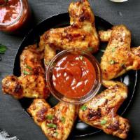 Barbeque Chicken Wings · Oven-baked chicken wings tossed in sweet barbeque sauce. Served with carrots and celery.