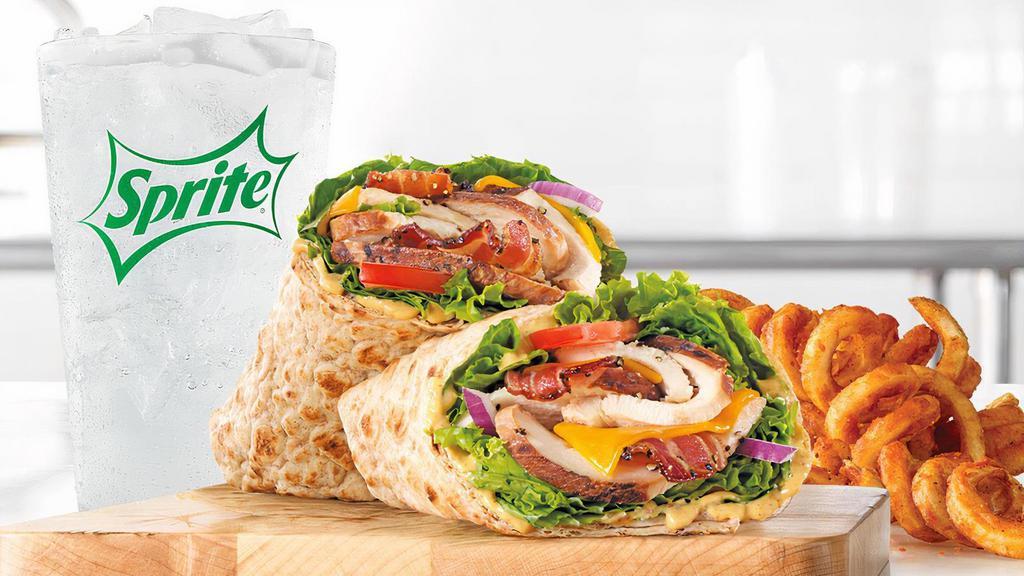 Chicken Club Wrap · Slow roasted chicken breast with pepper bacon, natural cheddar cheese, green leaf lettuce, red onion, honey mustard sauce, and tomato in an artisan wheat wrap. Visit arbys.com for nutritional and allergen information.