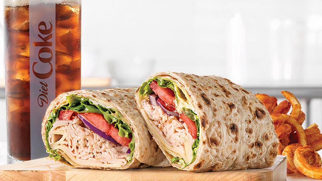 Roast Turkey & Swiss Wrap · Sliced roast turkey with Swiss cheese, lettuce, tomato, red onion, spicy brown honey mustard and mayo in an artisan wheat wrap. Visit arbys.com for nutritional and allergen information.