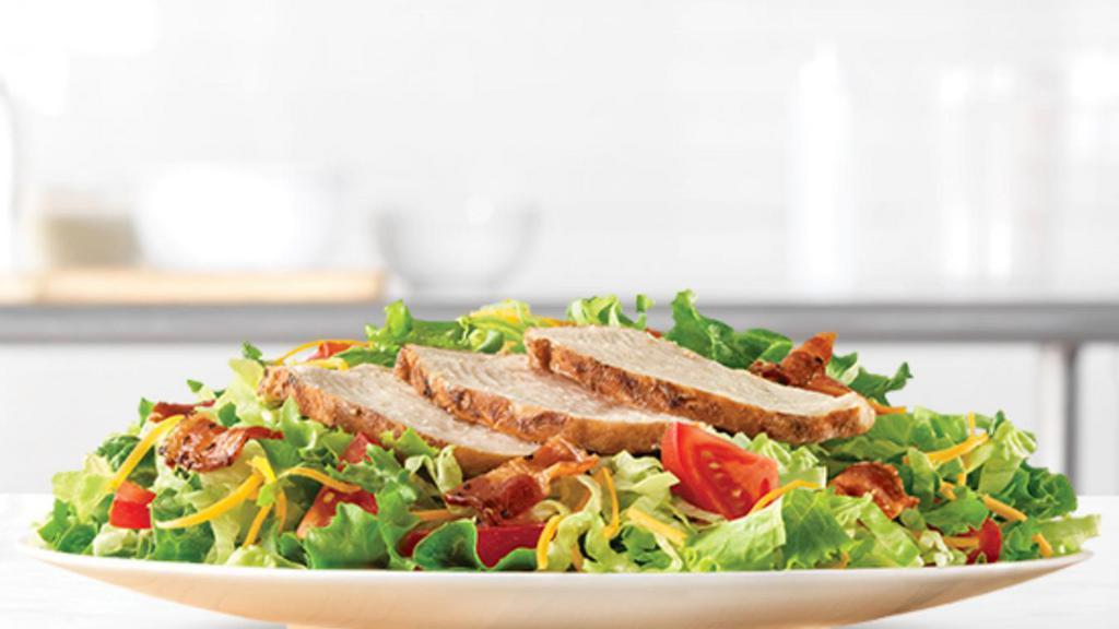Roast Chicken Salad · Slow roasted chicken and diced pepper bacon on a bed of chopped fresh lettuce with diced tomatoes and shredded cheddar cheese. Served with choice of dressing. Visit arbys.com for nutritional and allergen information.
