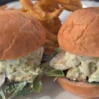 Fresh Fish Sliders · Fresh Grilled Fish with coleslaw, greens, hints of feta, and macadamia nuts all on a guava b...