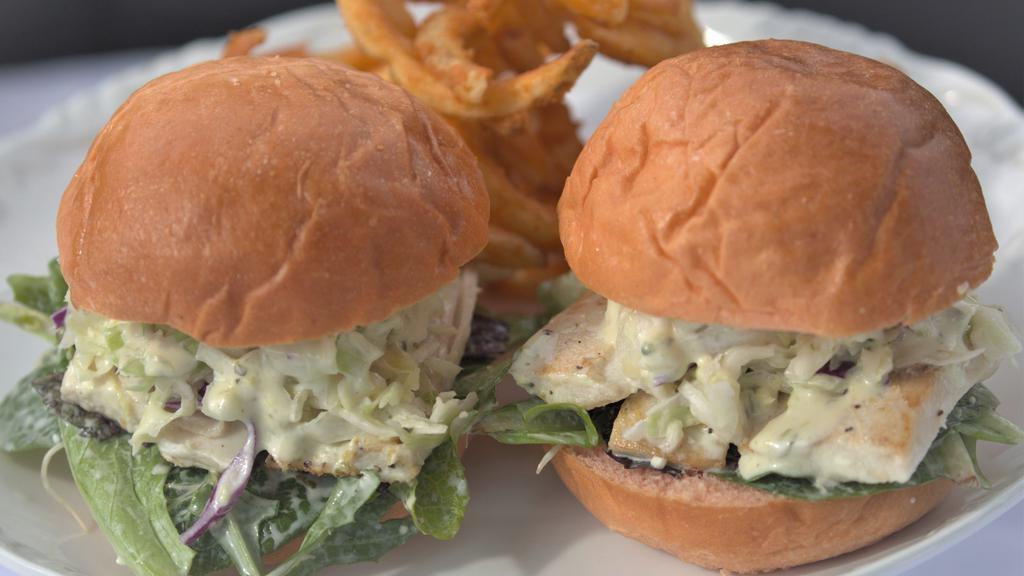 Fresh Fish Sliders · Fresh Grilled Fish with coleslaw, greens, hints of feta, and macadamia nuts all on a guava bun. Homemade guava buns and pineapple coleslaw.