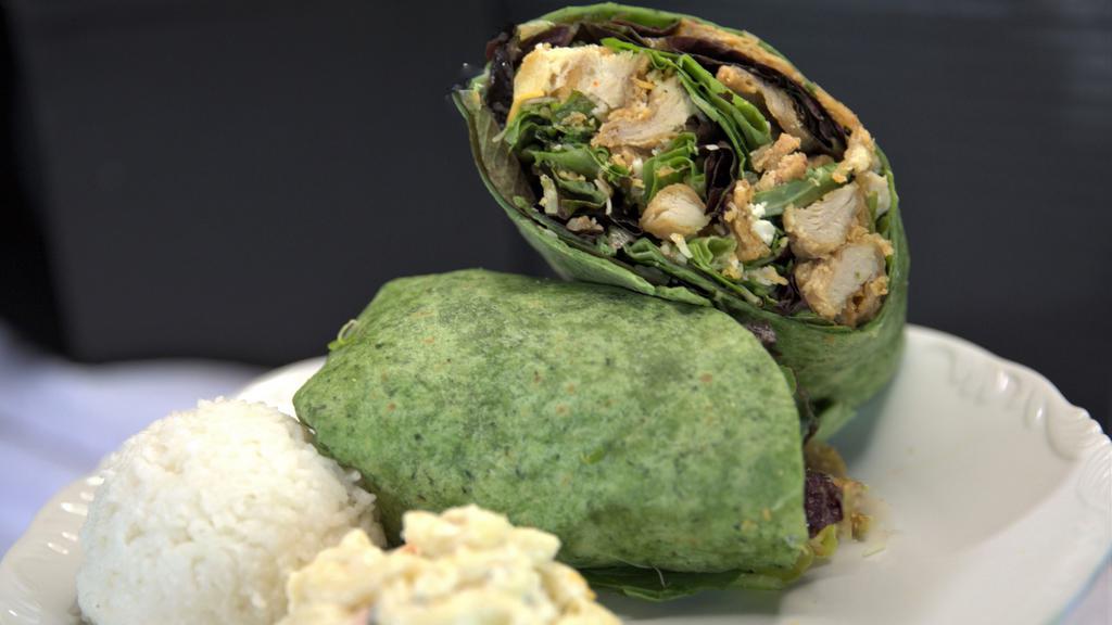Buffalo Chicken Wrap · Crispy fried chicken, organic greens, cheddar cheese, macadamia nuts, all wraped with our house-made Ranch and homemade buffalo ranch sauce. Comes with a side of rice and mac salad.