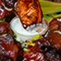 Caribbean Chicken Wings · Jerk spiced chicken wings, served with blue cheese & celery.