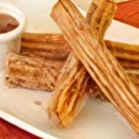 Churros | Latin Donut Sticks · Traditional Latin donut sticks served with dulce de leche and chocolate dipping sauces.