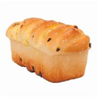 大椰檳 Coconut Raisin Bread · A loaf of soft bread with sweet shredded coconut and raisins.