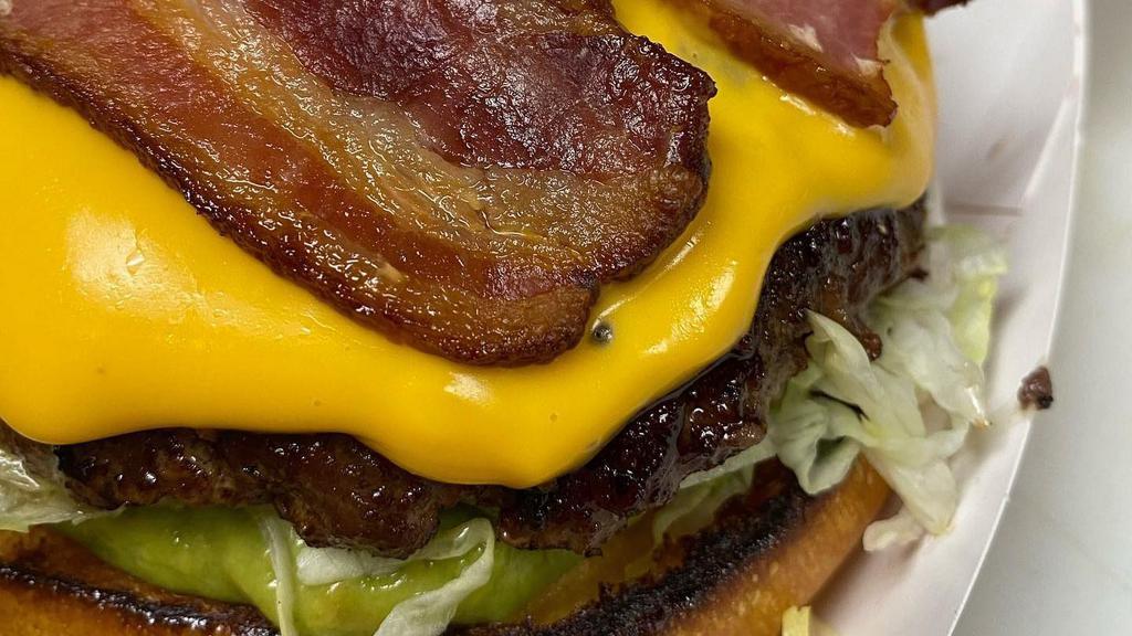 The Animal Burger · 5 oz. angus beef patty with lettuce, tomato, onions, pickles, sliced avocado, bacon, house-made whiz, and special sauce.