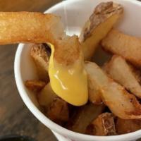 Cheesey Fries · Hand-cut fried idaho potatoes smothered with house-made velveeta cheese whiz.