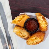 Mac N Cheese Spring Rolls · 3 cheeese mac n cheese wrapped in a thin springroll wrapper with Thai chili sauce.