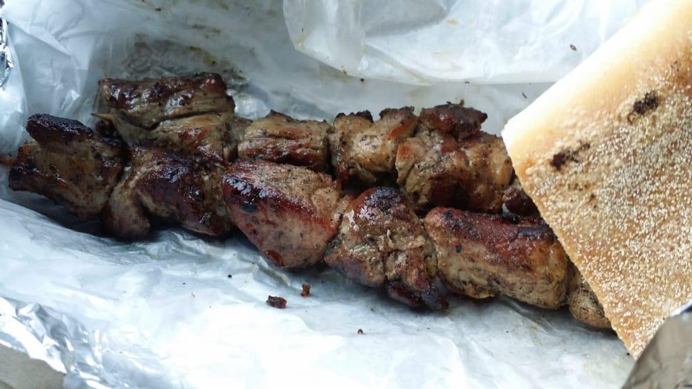 Pork Souvlaki · Marinated and hand skewered pork on a stick, grilled over a hardwood charcoal grill. Served with bread.
