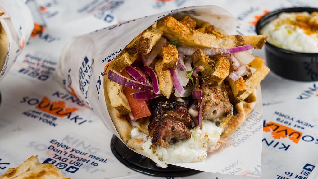 Pork Souvlaki Pita Sandwich · Perfectly grilled pork souvlaki wrapped inside of a warm and toasty pita with delicious fillings of your choosing.