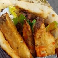 Chicken Souvlaki Pita Sandwich · Perfectly grilled chicken souvlaki wrapped inside of a warm and toasty pita with fillings of...
