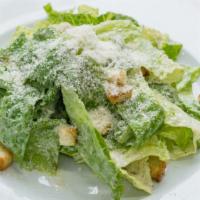 Caesar Salad · Freshly prepared salad topped with Romaine lettuce, sliced romano cheese, and homemade garli...