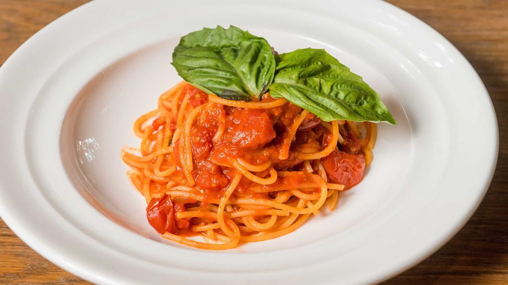 Spaghetti All Chitarra · Hand cut spaghetti with cherry tomatoes, and basil sauce.