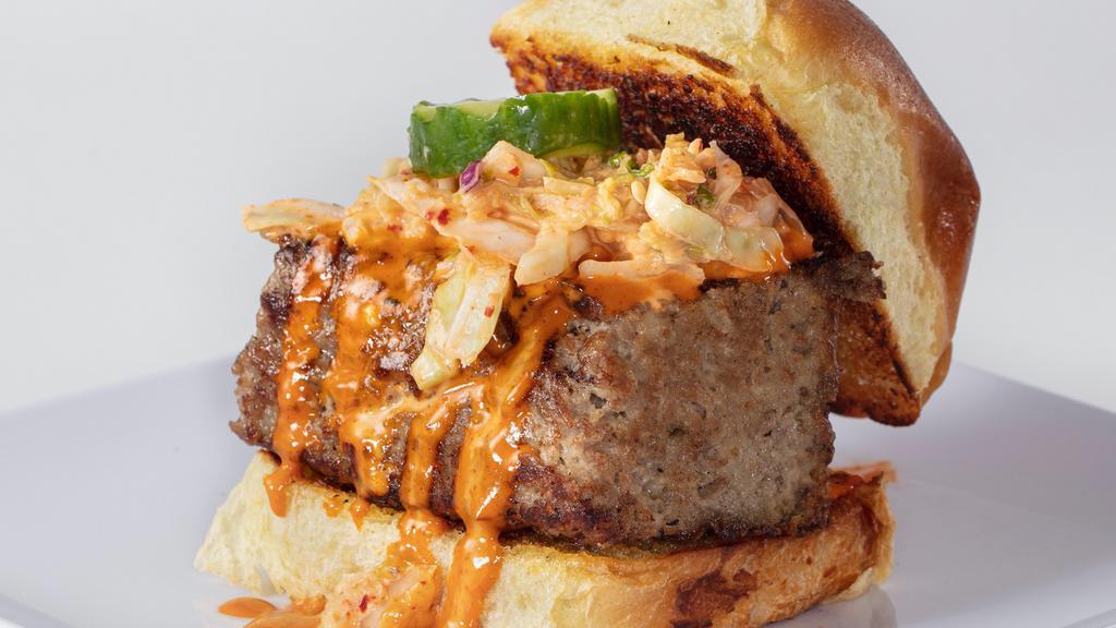 Bulgogi Meatloaf Slider · Four ounces of our delicious Korean BBQ Meatloaf brushed with sizzlin' Seoul Sauce and topped with kimchi coleslaw and a housemade sesame pickle on a buttered and toasted slider roll.