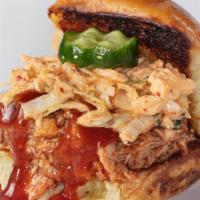 Pulled Pork Slider · Our savory pulled pork with kimchi coleslaw and a housemade sesame pickle on a buttered and ...