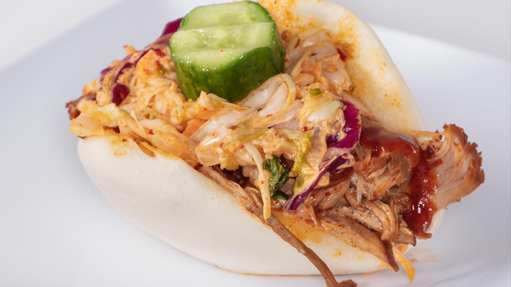 Pulled Pork Bun · Our savory pulled pork with kimchi coleslaw and a sesame pickle in a steamed Asian bun.