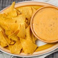 Queso Fundido · Famous Texas cheese dip with beans, pico, and spices.
