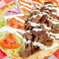 Gyro Pita · Served with lettuce, tomato, onion and white sauce in a pita .