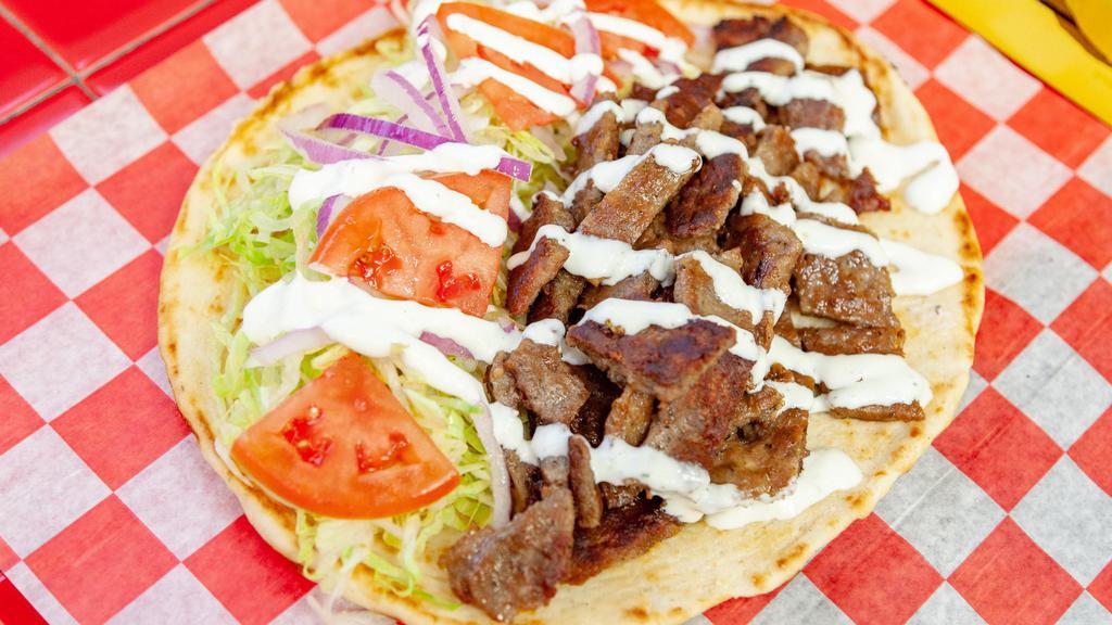 Gyro Pita · Served with lettuce, tomato, onion and white sauce in a pita .