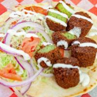 Falafel Pita · Served with lettuce, tomato, onion and white sauce in a pita .