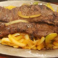 Churrasco / Skirt Steak · Servida con Tostones o Maduros o Arroz y Habichuela / Served with: Tostones or Sweet Plantai...