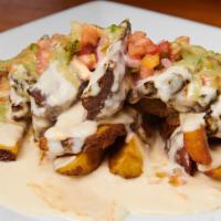 Fully Loaded Fries · Fresh cut cheese fries, skirt steak, chives, guacamole sauce and pico de gallo.
