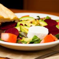 Goat Cheese Beet Salad · Arugula, cranberries, avocado, glazed walnuts, and red beets topped with goat cheese served ...