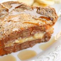 Banana Stuffed French Toast · Four slices of thick, egg-washed cinnamon bread stuffed with bananas and cream cheese, and t...