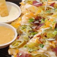 Joe'S Loaded Fries · Crispy crinkle-cut fries, topped with sharp cheddar cheese, hickory smoked bacon, jalapeños,...