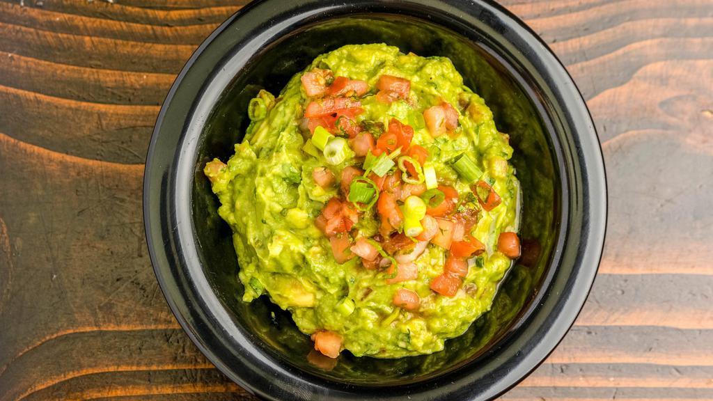 Guacamole · hand smashed avocado, tomato, roasted garlic, onions, cilantro, jalapeno, served with chips