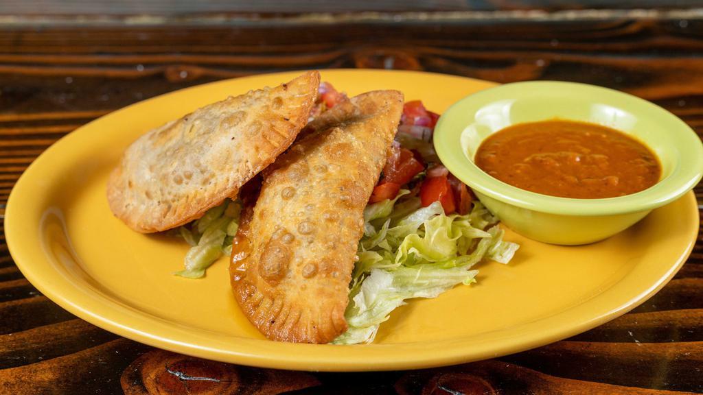 Empanadas · Beef empanadas (two) - spiced beef filled fried pastry chipotle tomato salsa.