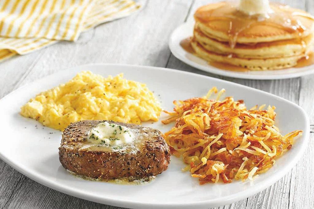 Top Sirloin Steak & Eggs · USDA Choice 6 oz. grilled Top Sirloin steak*, topped with garlic butter and served with two eggs*, choice of hash browns or breakfast potatoes and choice of three buttermilk pancakes, Mammoth Muffin® or buttered toast.