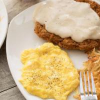 Country Fried Steak & Eggs · Lightly breaded steak topped with our country-style cream gravy.  Served with two eggs*, cri...