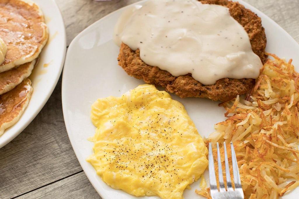 Country Fried Steak & Eggs · Lightly breaded steak topped with our country-style cream gravy.  Served with two eggs*, crispy hash browns or breakfast potatoes and choice of three buttermilk pancakes, fresh baked Mammoth Muffin® or buttered toast..