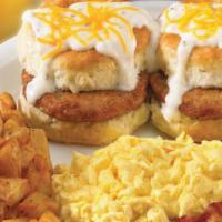 Country Sausage Biscuit Breakfast · Two fresh baked sausage biscuits topped with cream gravy and American cheese. Served with tw...