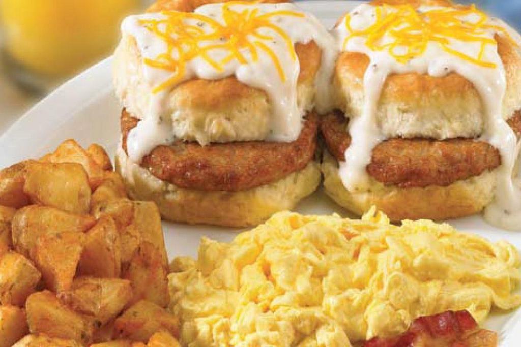 Country Sausage Biscuit Breakfast · Two fresh baked sausage biscuits topped with cream gravy and American cheese. Served with two eggs*, two Applewood smoked bacon strips and choice of crispy hash browns or breakfast potatoes. .