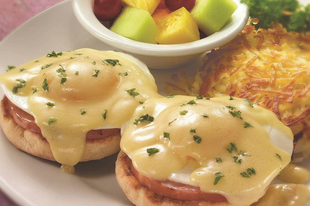 Classic Eggs Benedict · The tried-and-true favorite. Two basted eggs*, grilled ham and creamy hollandaise atop an English muffin. Served with Fresh Fruit and choice of crispy hash browns or breakfast potatoes..