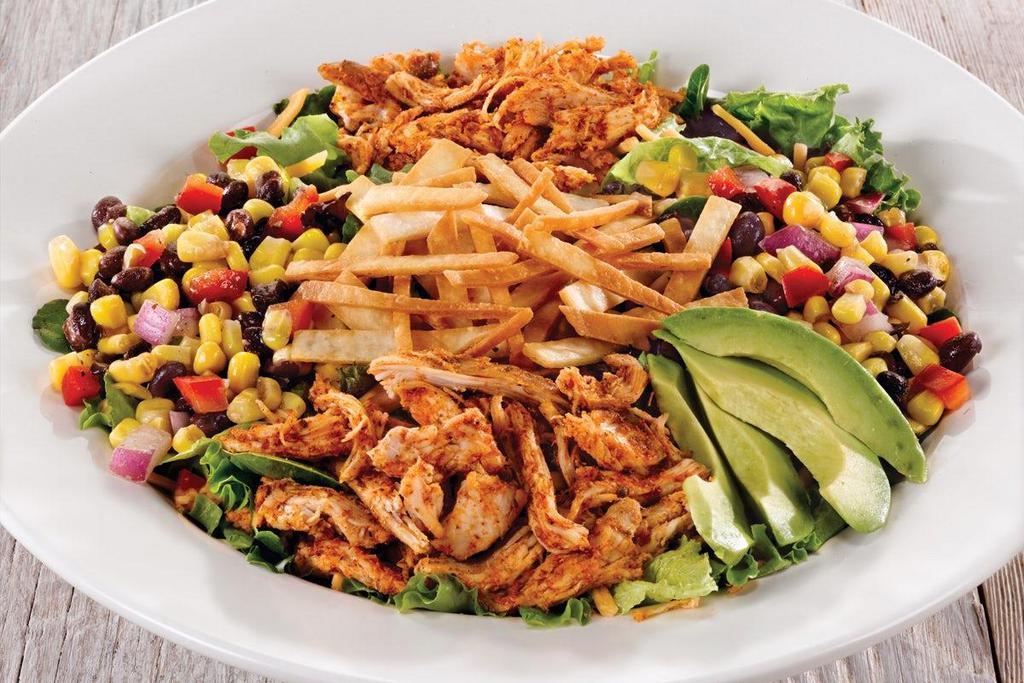 Southwest Avocado · A fresh-Mex salad with blackened chicken, black bean corn relish, American cheese and fresh avocado on garden greens. Garnished with crunchy tortilla straws and served with a zesty Chipotle Ranch dressing..