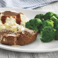 Top Sirloin Steak · USDA Choice 6 oz. grilled Top Sirloin steak*, topped with garlic butter and served with two ...