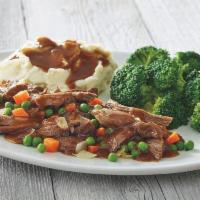 Classic Pot Roast · Tender chunks of braised beef, sweet green peas, tender carrots, onions and a hearty beef gr...