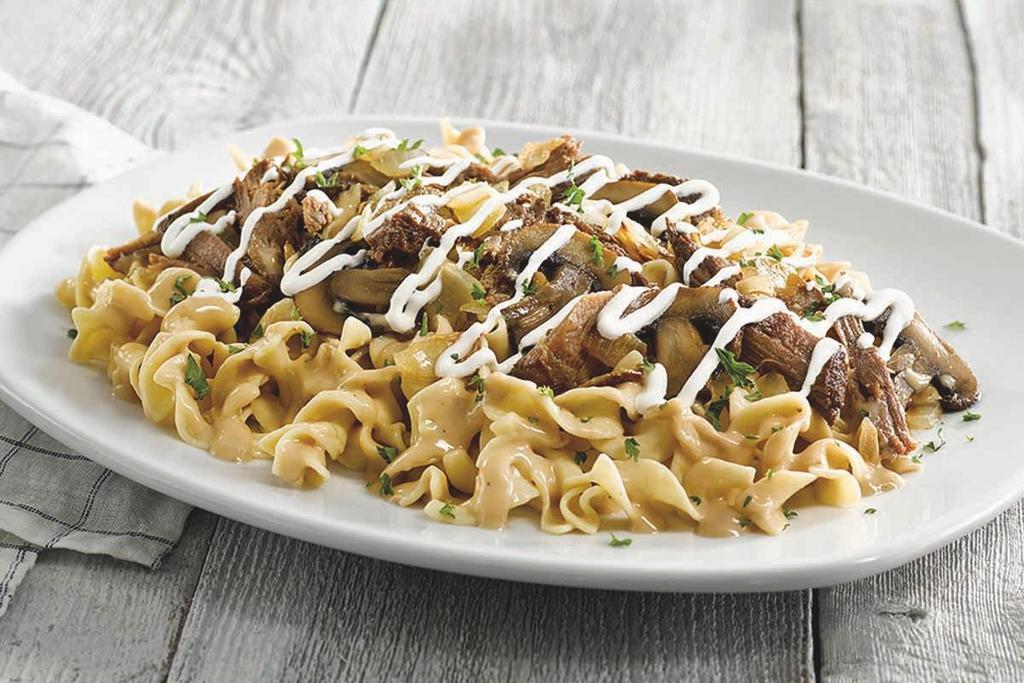 Pot Roast Stroganoff · Braised beef, mushrooms and onions served over tender egg noodles in a savory cream sauce with a drizzle of sour cream.