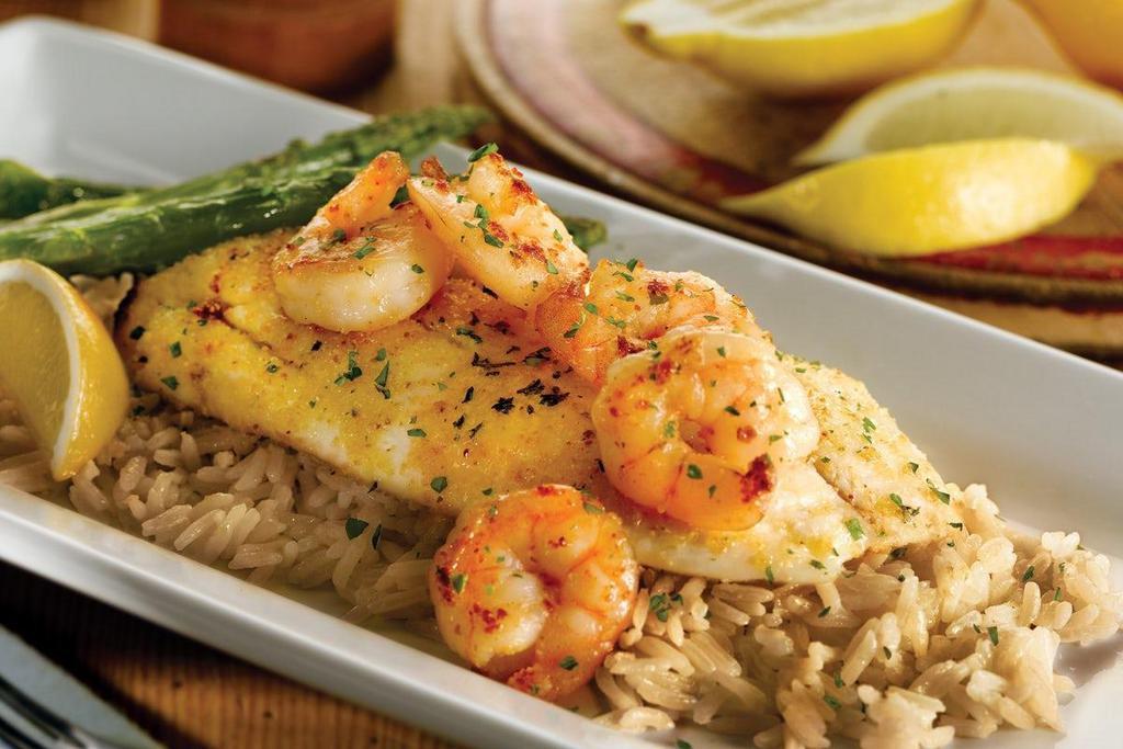 Grilled Fish & Shrimp · Garlic-seasoned white fish fillet topped with grilled shrimp and drizzled with garlic butter. Served over herb rice pilaf with grilled asparagus. Also available Cajun-seasoned..