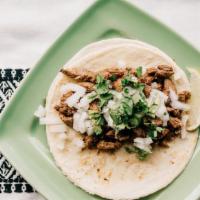 Asada Taco · Marinated grilled steak garnished with cilantro and onions.