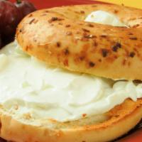 Onion Bagel With Cream Cheese · Fresh homemade onion bagel smothered with cream cheese. Choice of add-ons available.