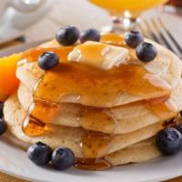Blueberry Buttermilk Pancakes · 3 perfectly fluffy blueberry pancakes served with a side of butter and syrup. Choice of add-...