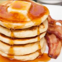 Bacon Buttermilk Pancakes · 3 perfectly fluffy pancakes topped with crispy bacon served with a side of butter and syrup....