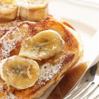 Banana French Toast · Sliced challah bread soaked in eggs and milk, then fried and topped with bananas served with...