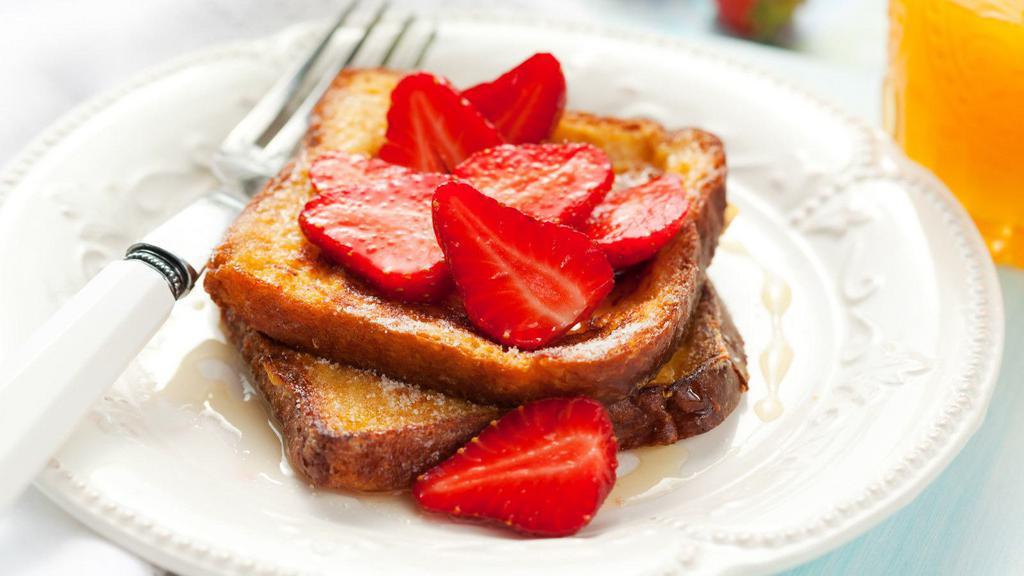 Strawberry French Toast · Sliced challah bread soaked in eggs and milk, then fried and topped with strawberries served with a side of butter and syrup. Choice of add-ons available.